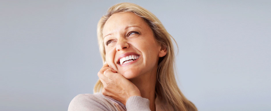 A woman laughing with a confident smile